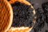 Set of butter and black caviar between biscuits on a dark background. top view.